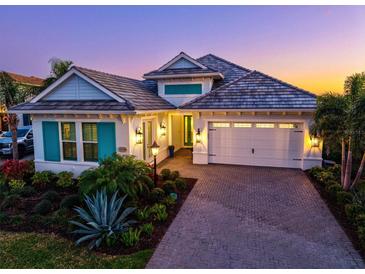 Charming single-story home boasts lush landscaping, brick driveway, and inviting curb appeal at 15430 Blackmoor Ter, Lakewood Ranch, FL 34202