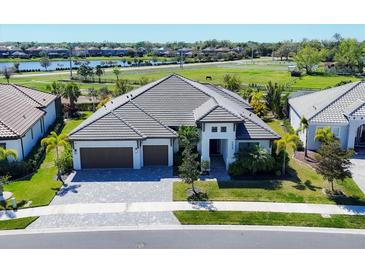 A luxurious two-story home featuring a beautifully paved driveway and a spacious three-car garage at 4629 Antrim Dr, Sarasota, FL 34240