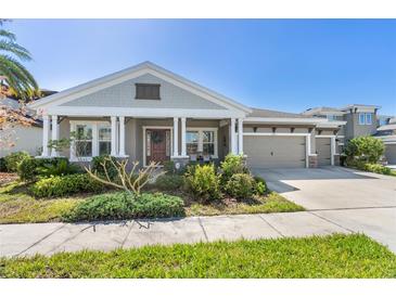 Charming single-story home with a well-manicured lawn and a three-car garage at 6913 Neopolitan Ct, Apollo Beach, FL 33572