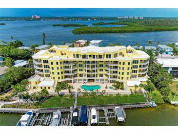 Beautiful waterfront condo building with boat docks and a refreshing pool overlooking scenic bay views at 9122 Midnight Pass Rd # 24, Sarasota, FL 34242