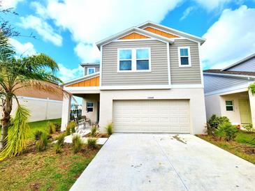 Inviting two-story home showcasing a modern design, two-car garage and well-maintained landscaping at 13068 Oak Hill Way, Parrish, FL 34219