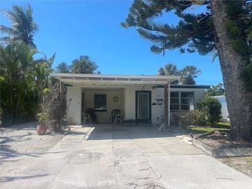 Charming single-story home featuring a covered entryway and a well-maintained front yard at 2714 Avenue C, Holmes Beach, FL 34217