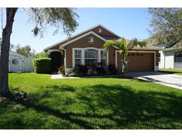 Charming single-story home with well-manicured lawn, lush landscaping, and a two-car garage at 6709 Rock Bridge Ln, Ellenton, FL 34222