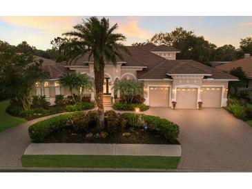Charming home featuring a well-manicured lawn, mature landscaping and a three-car garage at 13635 Legends Walk Ter, Lakewood Ranch, FL 34202