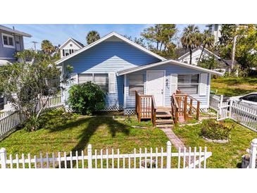 Charming blue home with a white picket fence and well-maintained front yard at 1704 Ballard Park Dr, Bradenton, FL 34205