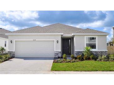 Charming single-story home with a two-car garage and beautifully landscaped front yard at 18224 Metado Dr, Lakewood Ranch, FL 34211