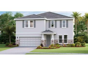 Inviting two-story home featuring a stone-accented garage, gray siding and a well manicured lawn at 18312 Thistleberry Pl, Lakewood Ranch, FL 34211