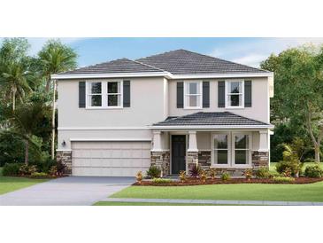 Charming two-story home featuring a stone veneer base, attached two car garage, and lush landscaping at 18320 Thistleberry Pl, Lakewood Ranch, FL 34211