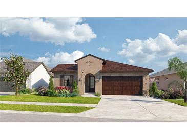 Charming one-story home with a well-maintained lawn, beautiful landscaping, and a two-car garage on a sunny day at 278 Hillshire Pl, Spring Hill, FL 34609