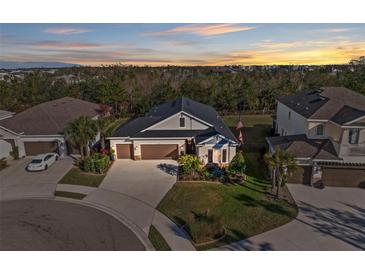 Beautiful home with well-manicured lawn, two-car garage, and colorful landscaping in a friendly neighborhood at 4611 Los Robles Ct, Palmetto, FL 34221