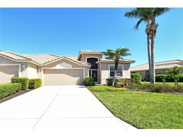 Charming single-story home with a two-car garage, lush landscaping, and a well-manicured lawn at 4629 Samoset Dr, Sarasota, FL 34241
