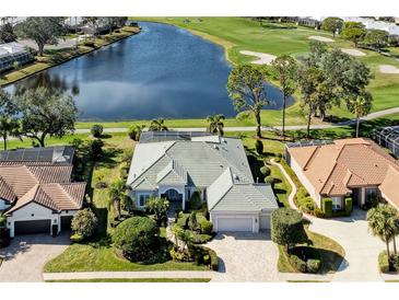 Expansive aerial view of a charming home overlooking a pristine lake and lush golf course at 5224 88Th E St, Bradenton, FL 34211
