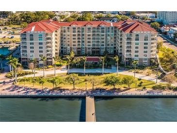 Stunning waterfront condo building featuring lush landscaping, a private pier, and resort-style amenities at 808 3Rd W Ave # 205, Bradenton, FL 34205