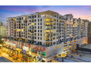 Modern condominium building featuring sleek architecture, ample windows, and private balconies in a vibrant city setting at 111 S Pineapple Ave # 804, Sarasota, FL 34236