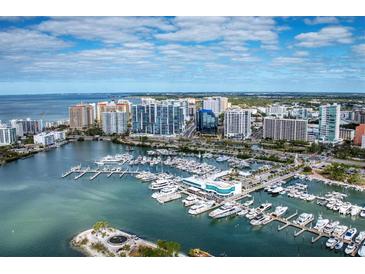 Stunning aerial view of the city skyline, marina, and waterfront of this luxury highrise condo at 1155 N Gulfstream Ave # 1205, Sarasota, FL 34236