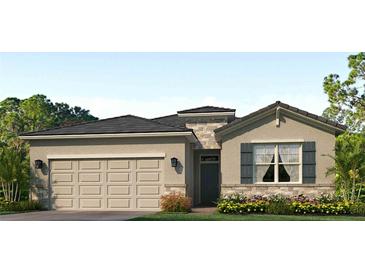 Charming single-story home with a two-car garage and stone accents, enhancing its curb appeal at 18224 Beach Ranch Ter, Lakewood Ranch, FL 34211
