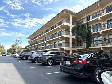 Condo exterior with multiple floors, balconies, and parking in front on a sunny day at 515 30Th W Ave # H303, Bradenton, FL 34205