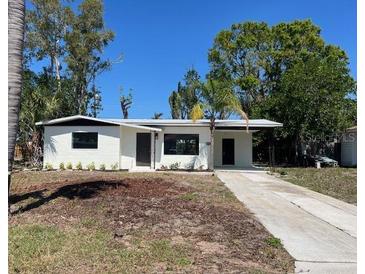 Well-maintained single-story home with a lush green lawn and a charming, welcoming entrance at 2404 Lehigh Ave, Bradenton, FL 34207