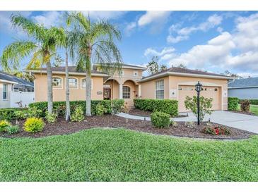 Charming single-Gathering home features a well-manicured lawn, mature landscaping, and a welcoming entrance at 11835 Hollyhock Dr, Lakewood Ranch, FL 34202