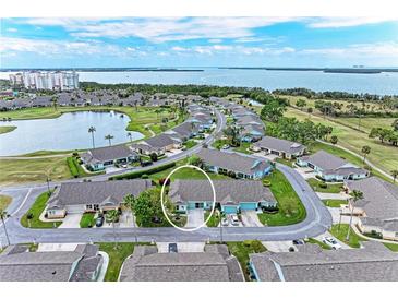 Waterfront community home with lush landscaping, lake, and golf course access with water views in the background at 3009 Live Oak Ln # 33, Palmetto, FL 34221