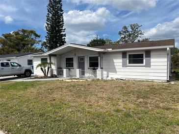 Charming single-story home with a well-maintained lawn and decorative accents at 3525 Emory Dr, Holiday, FL 34691
