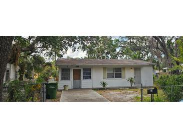 Modest single-story home featuring a cozy front yard, and natural surrounding landscaping at 1778 23Rd St, Sarasota, FL 34234