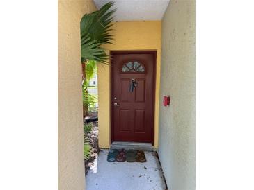 Charming front door with a secure lock, inviting entrance to the property at 5681 Bentgrass Dr # 13-201, Sarasota, FL 34235