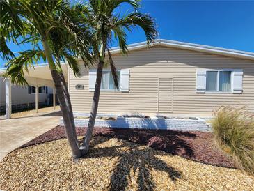 Inviting home exterior with a well-maintained yard and charming curb appeal, enhanced by lush palm trees at 808 53Rd E Ave # 273, Bradenton, FL 34203