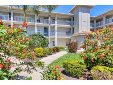 Beautiful condo exterior with lush landscaping, walkway and well-maintained facade at 9620 Club South Cir # 5306, Sarasota, FL 34238