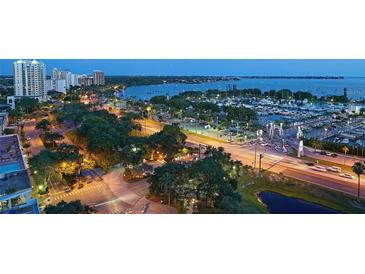 Beautiful aerial view showcasing the city and bay with lush landscaping and a bustling marina at 101 S Gulfstream Ave. # 9C, Sarasota, FL 34236