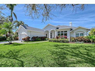 Beautiful single-Gathering home with manicured front yard, garden, and attached two-car garage at 1110 93Rd Nw St, Bradenton, FL 34209