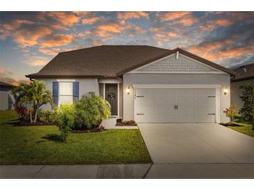 Charming single-story home with manicured lawn, two-car garage, and beautiful landscaping at 11221 Gallatin Trl, Parrish, FL 34219