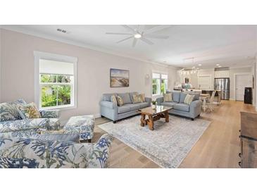 Spacious living area with stylish furniture, including couches and patterned armchairs at 1623 8Th W Ave, Bradenton, FL 34205