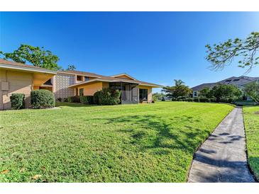 Beautifully maintained lawn and shrubbery highlight this cozy home's exterior at 2233 Beneva Ter # 2232, Sarasota, FL 34232