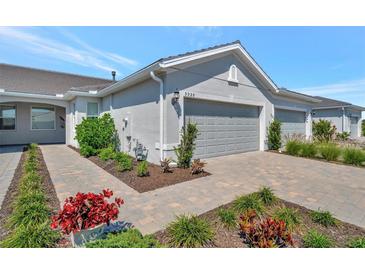 Charming home exterior with a well-manicured lawn and a two-car garage, offering great curb appeal at 9928 Bright Water Dr, Englewood, FL 34223