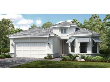 Beautiful single-Gathering home featuring a pristine white exterior, well-manicured landscaping, and an attached two-car garage at 14919 Contenta Loop, Bradenton, FL 34211