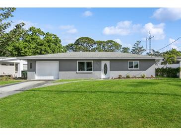 Charming single-story home with a well-manicured lawn and a classic front door at 2039 Kai Dr, Sarasota, FL 34231