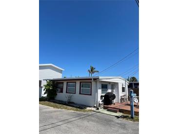 Charming single-story home featuring a well-maintained exterior and cozy front porch at 2601 Gulf N Dr # 214, Bradenton Beach, FL 34217