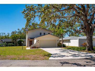 Charming two-story home featuring a two-car garage and well-maintained landscaping at 332 Bearded Oaks Cir, Sarasota, FL 34232