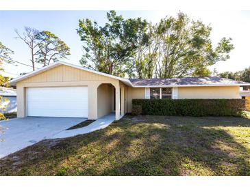 Charming single-story home featuring an attached garage and well-maintained front yard at 6235 Carlton Ave, Sarasota, FL 34231