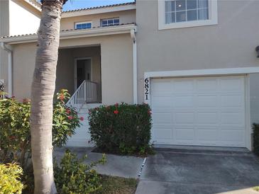 Charming townhome featuring an attached single car garage and a welcoming, elevated front entrance at 6821 Fairview Ter # 6821, Bradenton, FL 34203