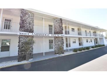 Condo exterior features stone accents, white paint, railings, and ample parking at 3900 Roxane Blvd # 10A, Sarasota, FL 34235
