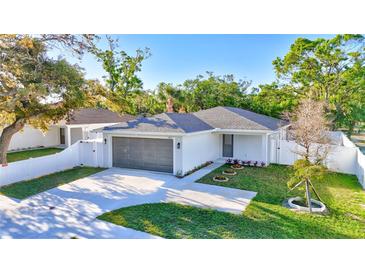Charming single-story home with a well-manicured front lawn, two car garage, and beautiful landscaping at 1422 19Th St, Sarasota, FL 34234