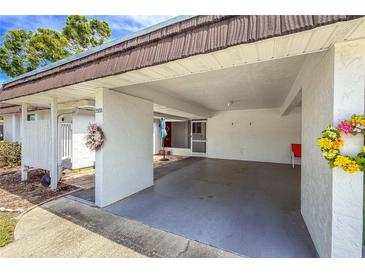 Spacious carport offers covered parking and easy access to the home's entrance and decorated with seasonal decorations at 3908 Panola Ln # 193, Sarasota, FL 34232