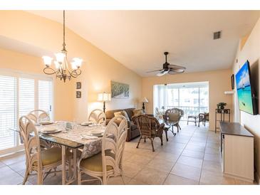 Comfortable living and dining area with access to the lanai offers inviting space at 5633 Sheffield Greene Cir # 40, Sarasota, FL 34235