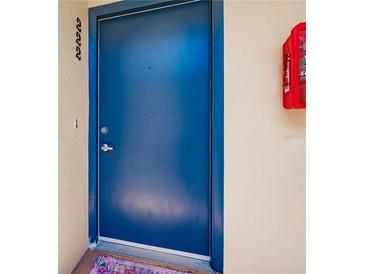 Blue painted front door with silver handle on a cream colored wall at 700 Golden Beach Blvd # 222, Venice, FL 34285