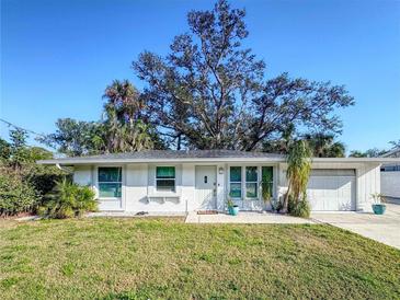 Charming single-story home boasts a well-maintained lawn and attached one-car garage at 240 Pocono E Trl, Nokomis, FL 34275