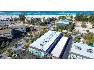 An aerial view shows the property's proximity to the beach and nearby amenities at 4307 Gulf Dr # 202, Holmes Beach, FL 34217