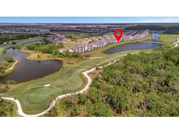 Aerial view of a residential community on a golf course with pond and manicured lawns at 17626 Gawthrop Dr # 305, Bradenton, FL 34211