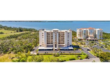 Aerial view of a condominium complex with lush landscaping, parking, and views of the intercoastal waterway at 2625 Terra Ceia Bay Blvd # 206, Palmetto, FL 34221